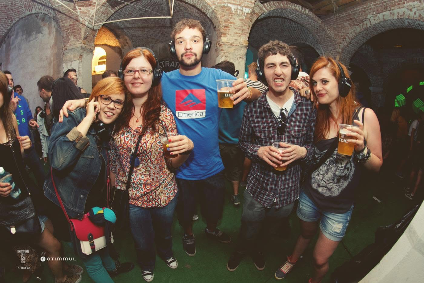 Festival visitors wearing headphones beneath the brick arches at Stables, Electric Castle 2014.